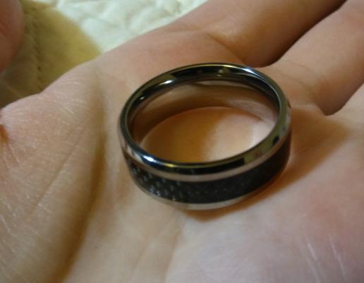 a silver ring with a black carbon fiber inlay
