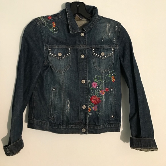 a girl's jean jacket with apliques